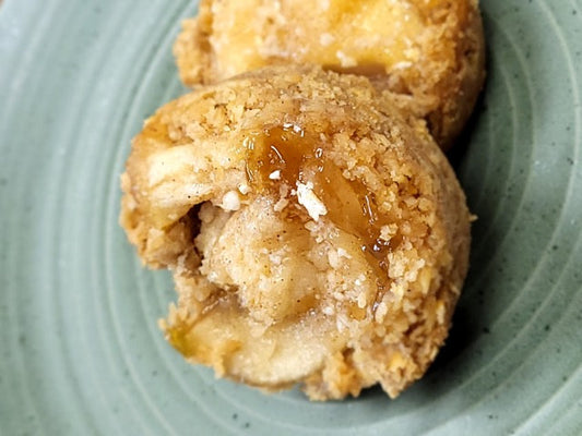 Mini oatmeal cups filled with baked apple on a green plate.