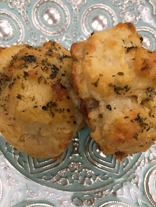 golden baked savoury biscuits on a pale blue plate.