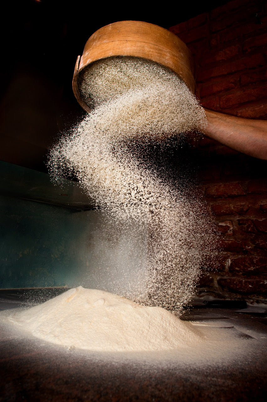 gluten free flour flowing down from a sieve with a  made in Canada banner